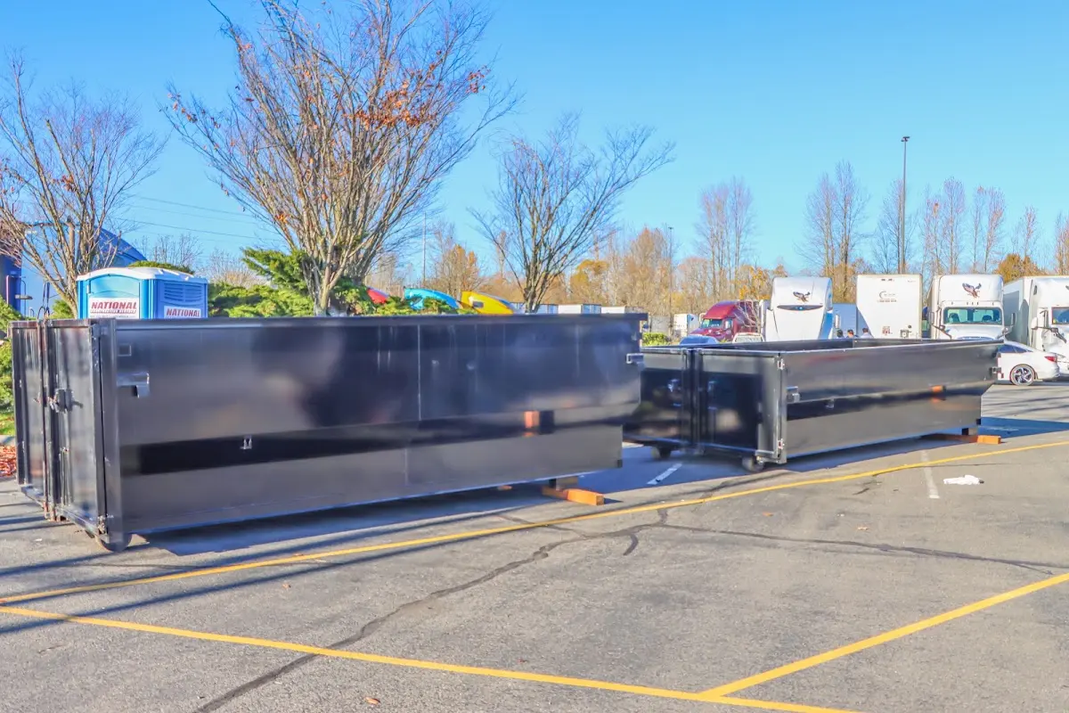 Professional dumpster rental service with roll-off container on residential driveway in Mooresville